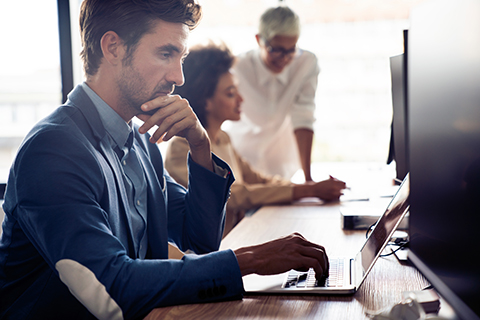 Construction worker leveraging IT support for construction.