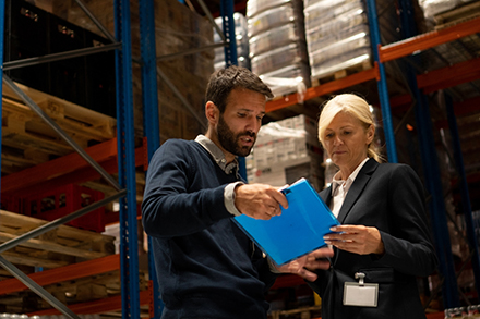 Co-workers discussing supply chain risk management.